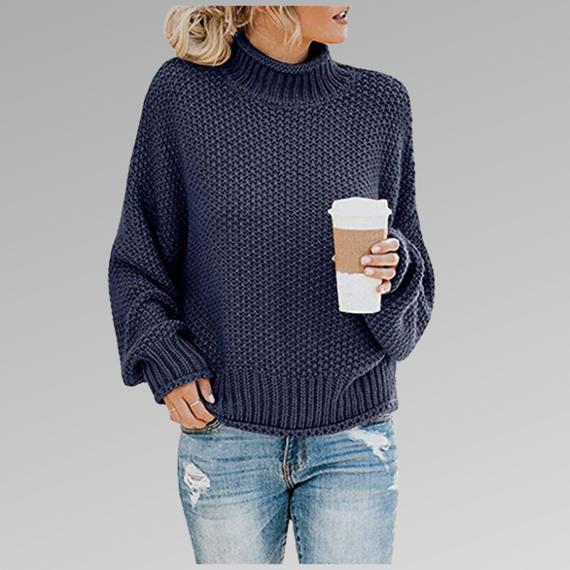Woman in a blue knit sweater with a coffee cup, wearing ripped jeans. Fashion trend, fall fashion, casual style, cozy look.