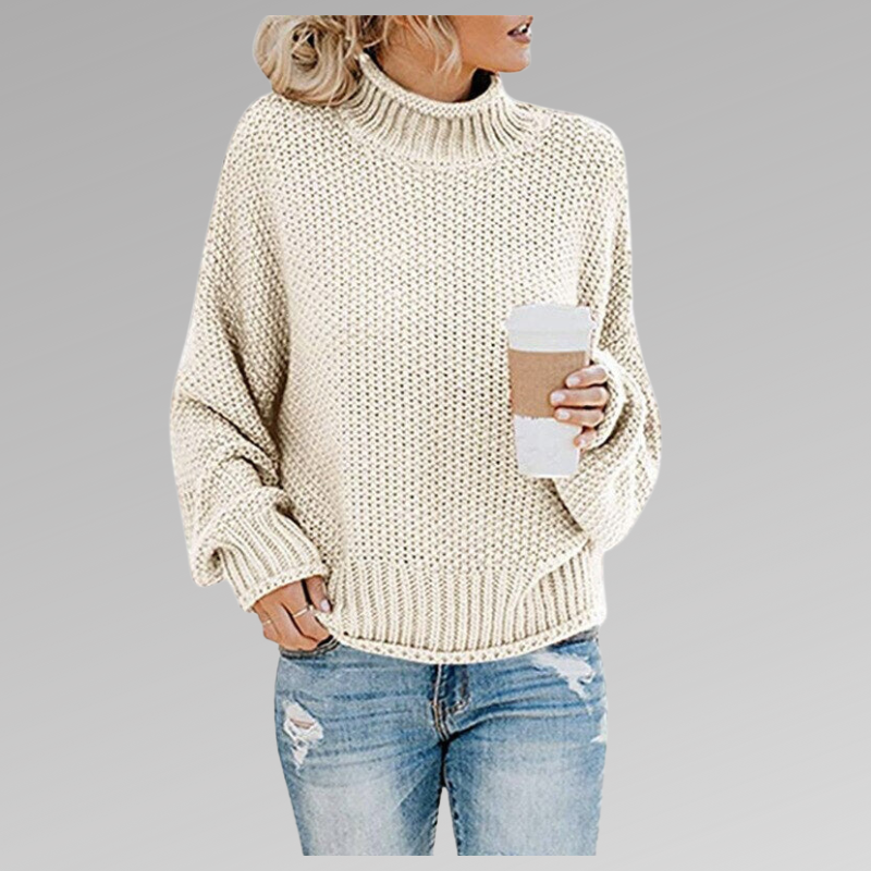 Woman in a cream-colored turtleneck knit sweater holding a coffee cup, wearing ripped jeans. Fashion trend, fall fashion, casual look.