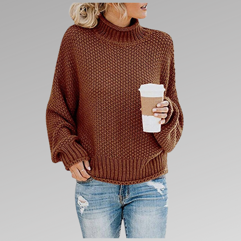 Woman in a brown knit sweater with a coffee cup, wearing ripped jeans. Fall fashion, cozy look, casual style.