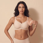 Woman holding a beige bra against a beige background